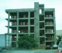 Gravity designed reinforced concrete frame buildings with unreinforced masonry infill walls.