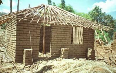 Unburnt brick wall building with pitched roof (nyumba ya zidina )