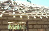 Unburnt brick wall building with pitched roof (nyumba ya zidina )